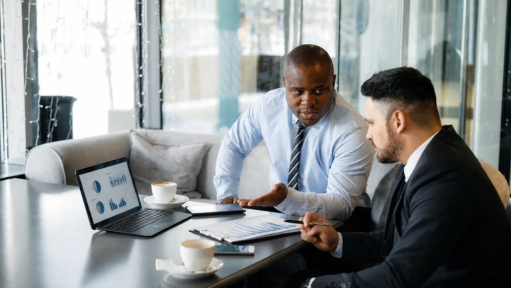 An adviser walking a client through management accounts and charts